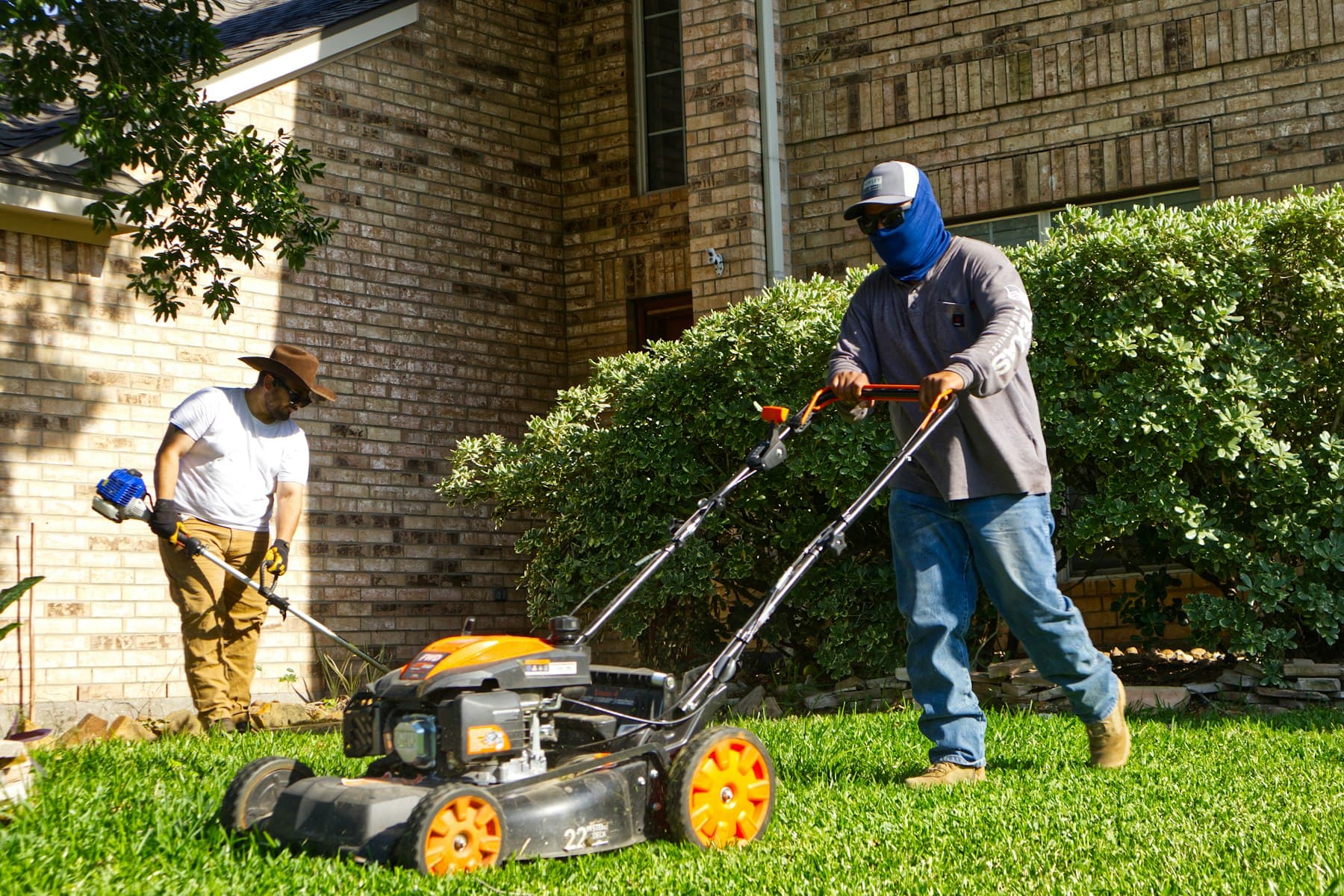 Lawn-care crew mowing a residential lawn